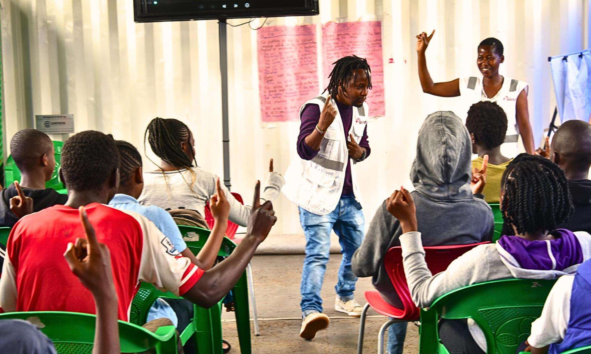 MSF staff lead youth in an ice breaker session at the Dandora Youth Friendly Center in Nairobi, Kenya.