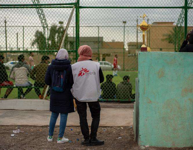 Members of MSF's team watch a football match in Hawija, Iraq.