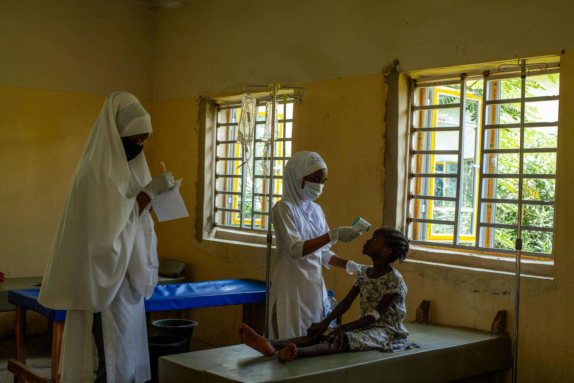 A nurse takes a young patient's temperature at the MSF cholera treatment center in Kano.
