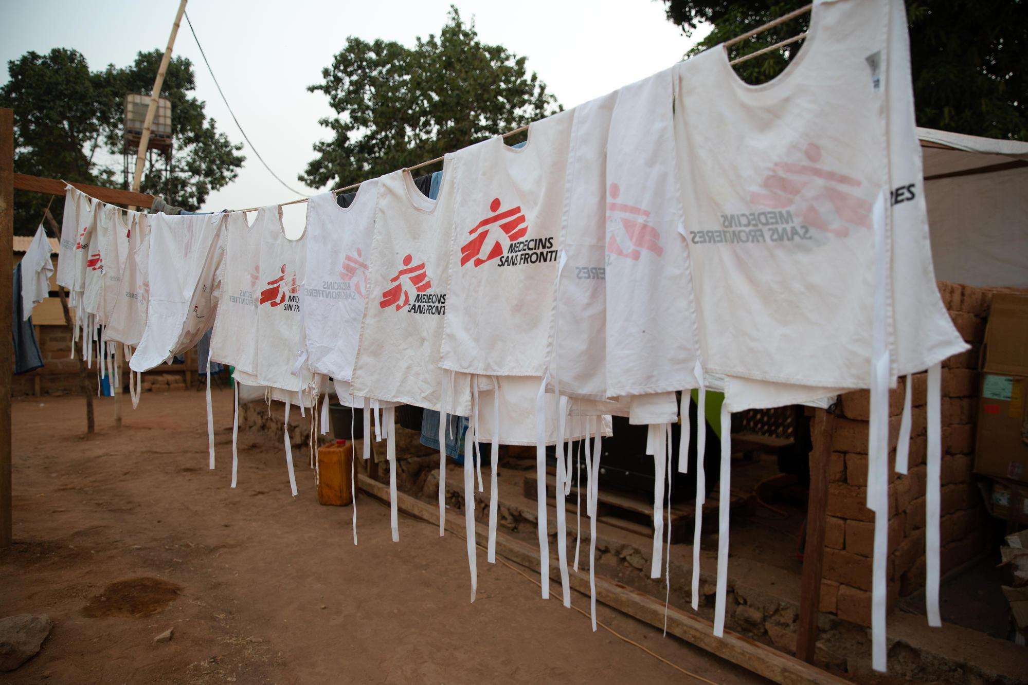 White vests with MSF logo hanging on a clothesline