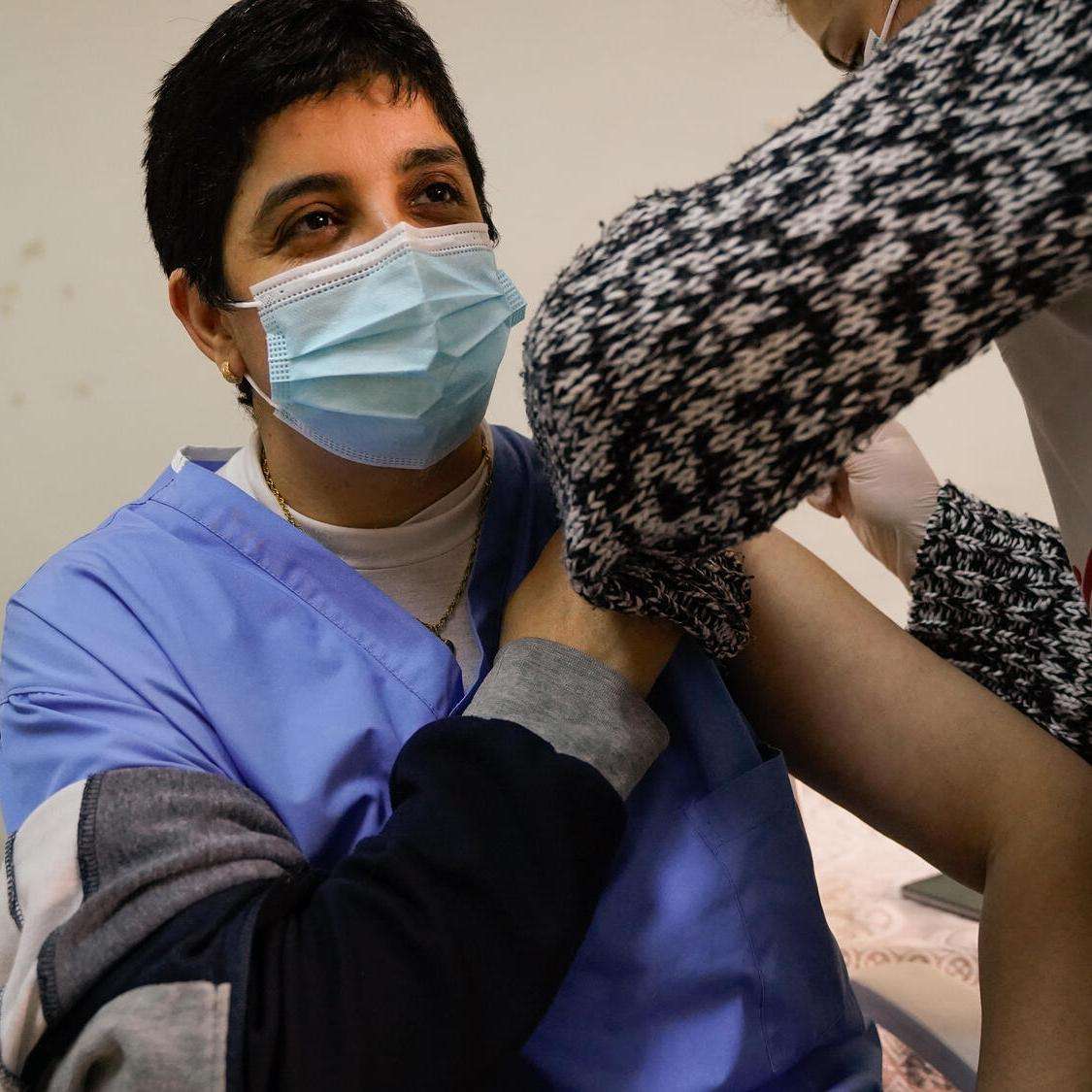 MSF medical mobile team member vaccinates a patient in northern Lebanese city of Tripoli.