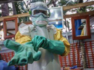 An MSF team member prepares to enter the high risk zone of the Ebola treatment center in Mangina, DRC.