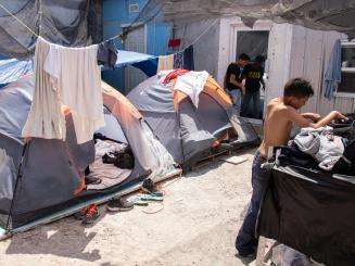 Many asylum seekers are forced to sleep in tents near the border.