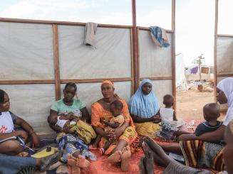 Mothers and their children in a women's club session in an IDP camp in Kongoussi, Burkina Faso