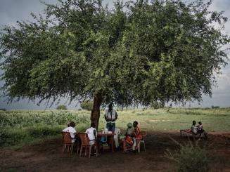 A community group led by MSF sits under a tree in Abyei, South Sudan.