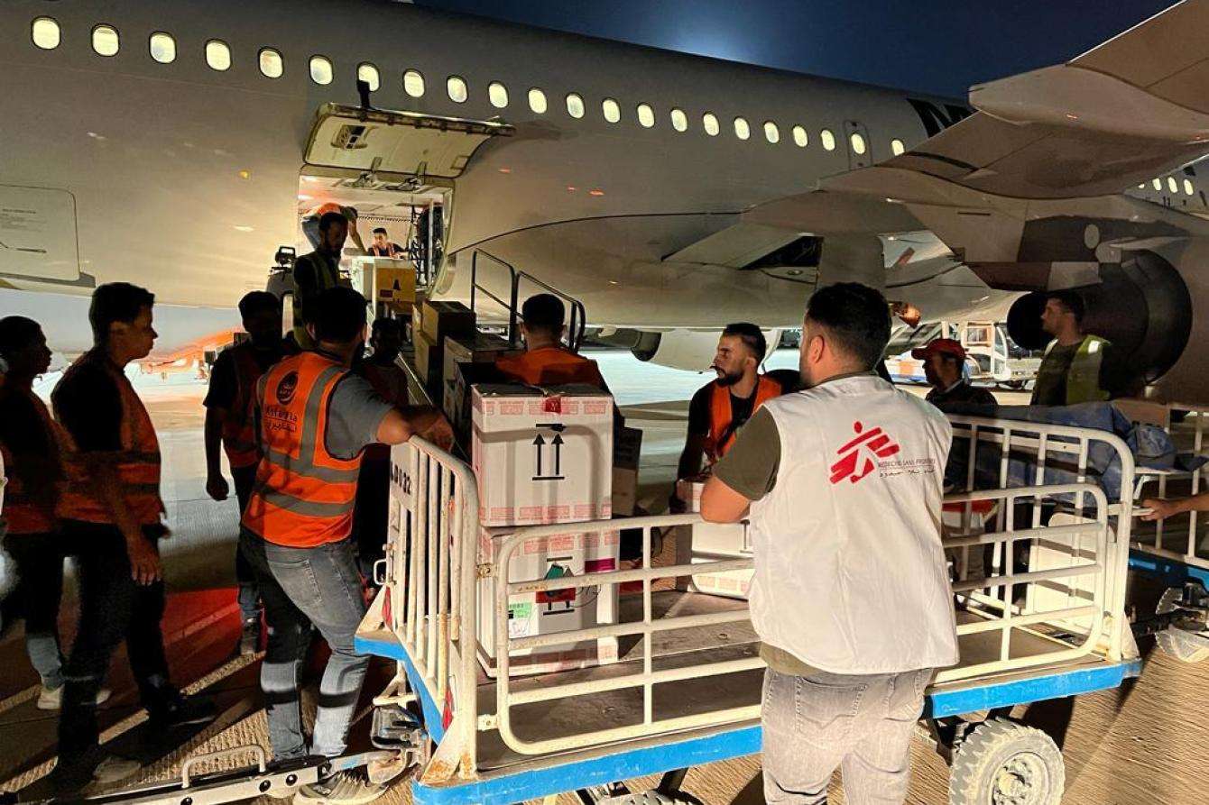 MSF aid workers unload aid deliveries from a plane in Libya in response to floods caused by Storm Daniel. 