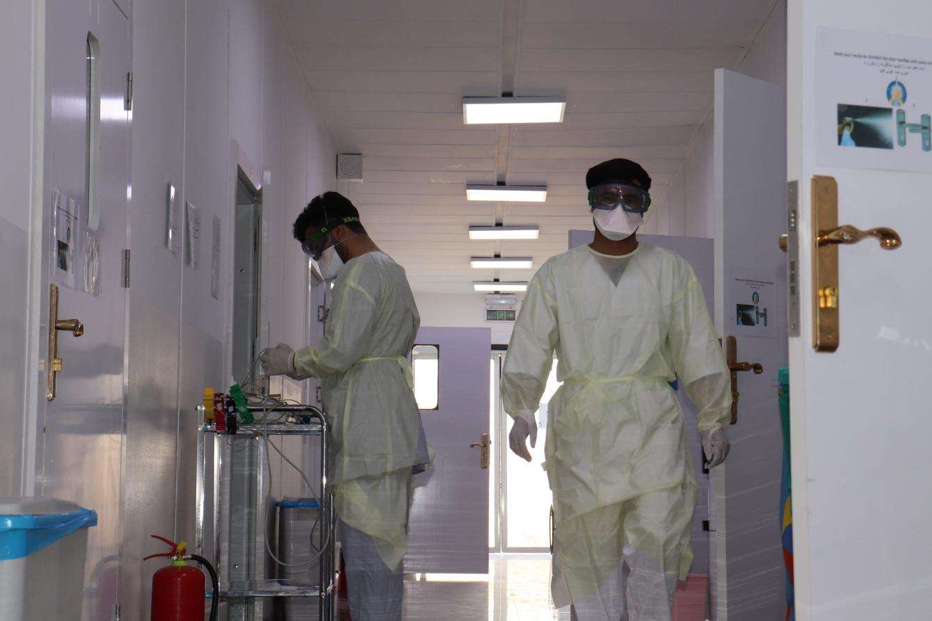 Two medics walking through a hospital floor