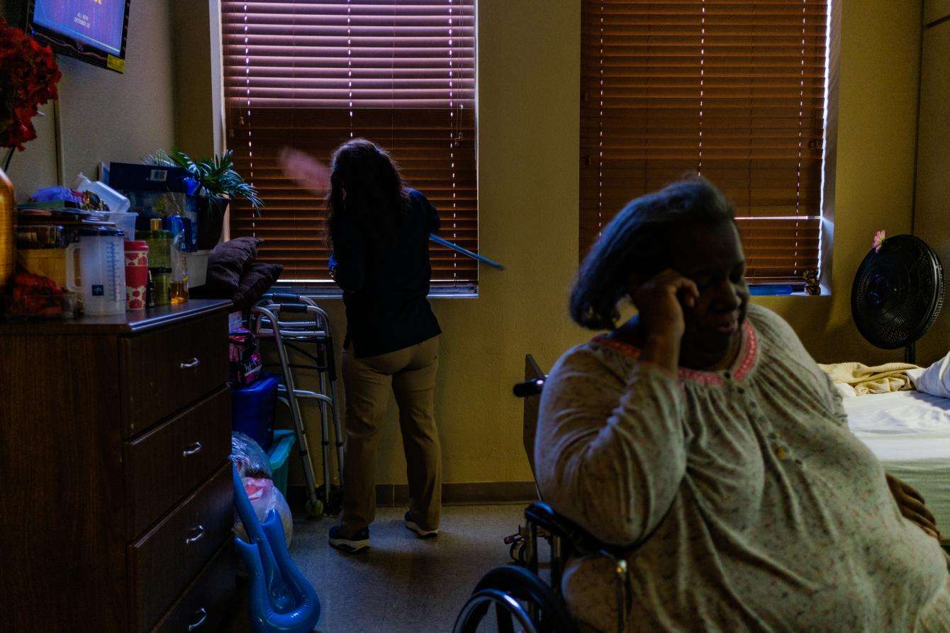 An environmental services (EVS) staff member cleans a resident's room at Focused Care at Beechnut, a long-term nursing care facility in Houston, Texas, that was affected by the global COVID-19 pandemic.
