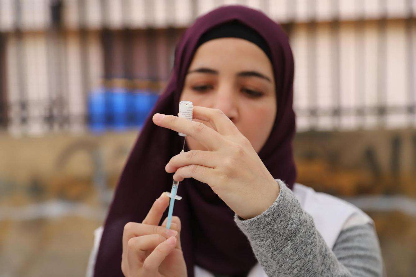 An MSF nurse fills syringes as part of a polio vaccination campaign in a refugee camp in Lebanon.