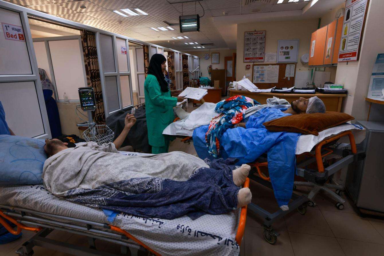 Patients on hospital beds receiving care at Al Aqsa Hospital in Gaza.