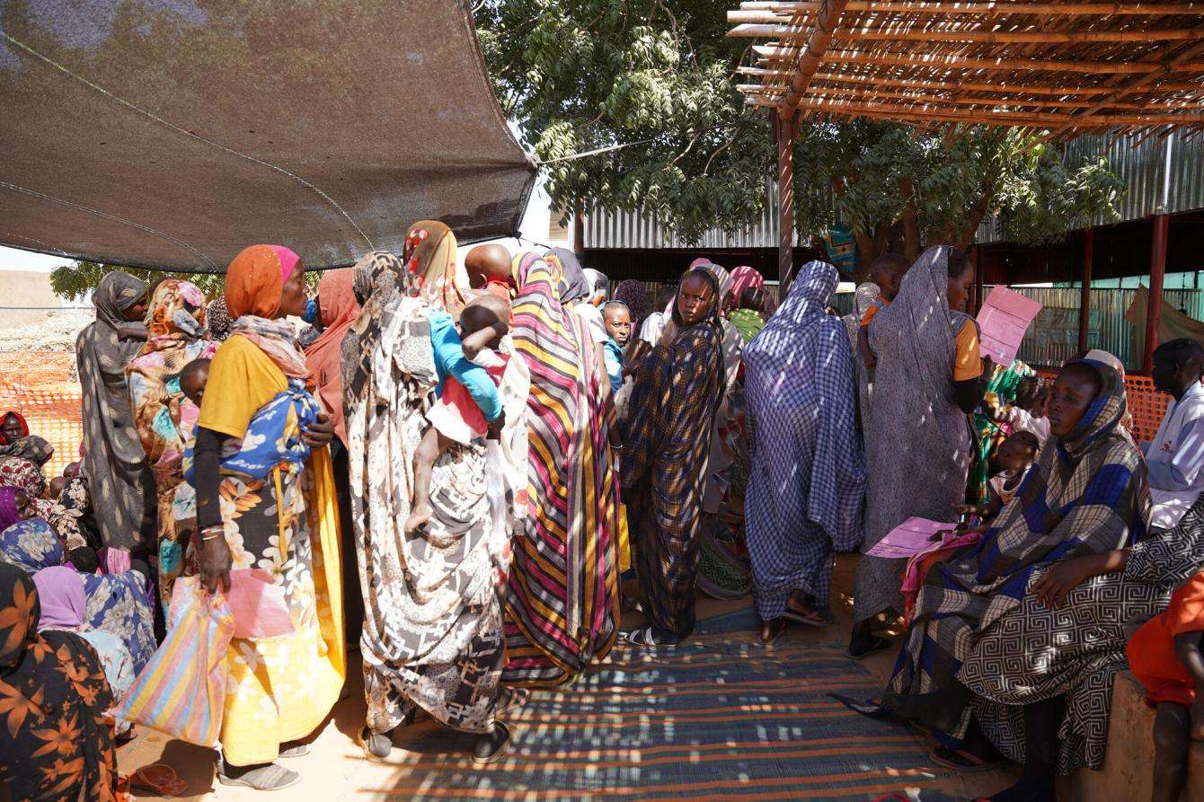 People queue for therapeutic feeding in Zamzam camp, North Darfur