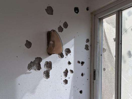 Bullet holes in the wall of MSF office in Gaza