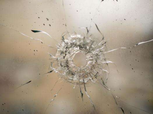 Bullet hole in glass window inside Jenin refugee camp after an Israeli military raid in the West Bank, Palestine.