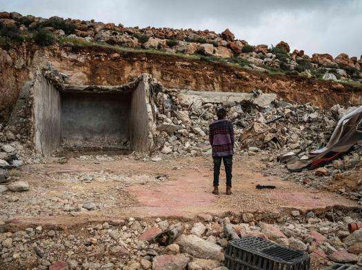 A Palestinian woman looks at the rubble left of her home after it was demolished by Israeli forces.