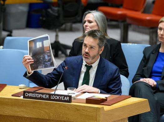 Christopher Lockyear, secretary general of Médecins Sans Frontières (MSF), holds up an image of the destroyed MSF shelter in Al-Mawasi in Khan Younis, Gaza, at a UNSC briefing.