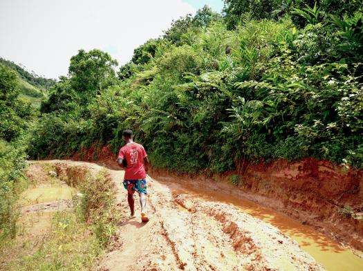 Man walks on a dirt road in Madagascar.