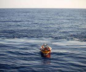 An aerial view of a small MSF rescue boat in the middle of the  Mediterranean sea.
