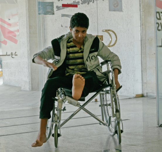 A disabled child in a wheelchair at MSF's reconstructive surgery hospital in Amman, Jordan.