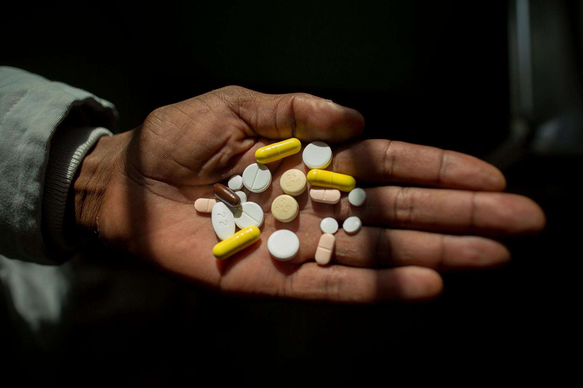 Simphiwe holds his medication, he takes up to 26 pills a day to treat XDR-TB. Here he holds his morning selection, which includes delamanid, one of the newest DR-TB drugs, which Simphiwe is taking for the first time today. 