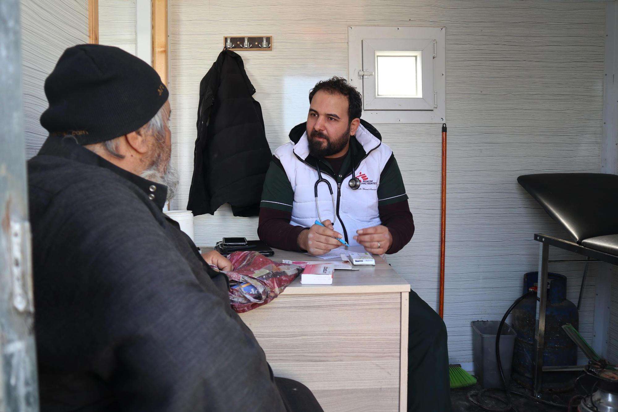 A patient talks with a doctor at MSF's mobile clinic in Qadimoon camp, Northwest Syria.