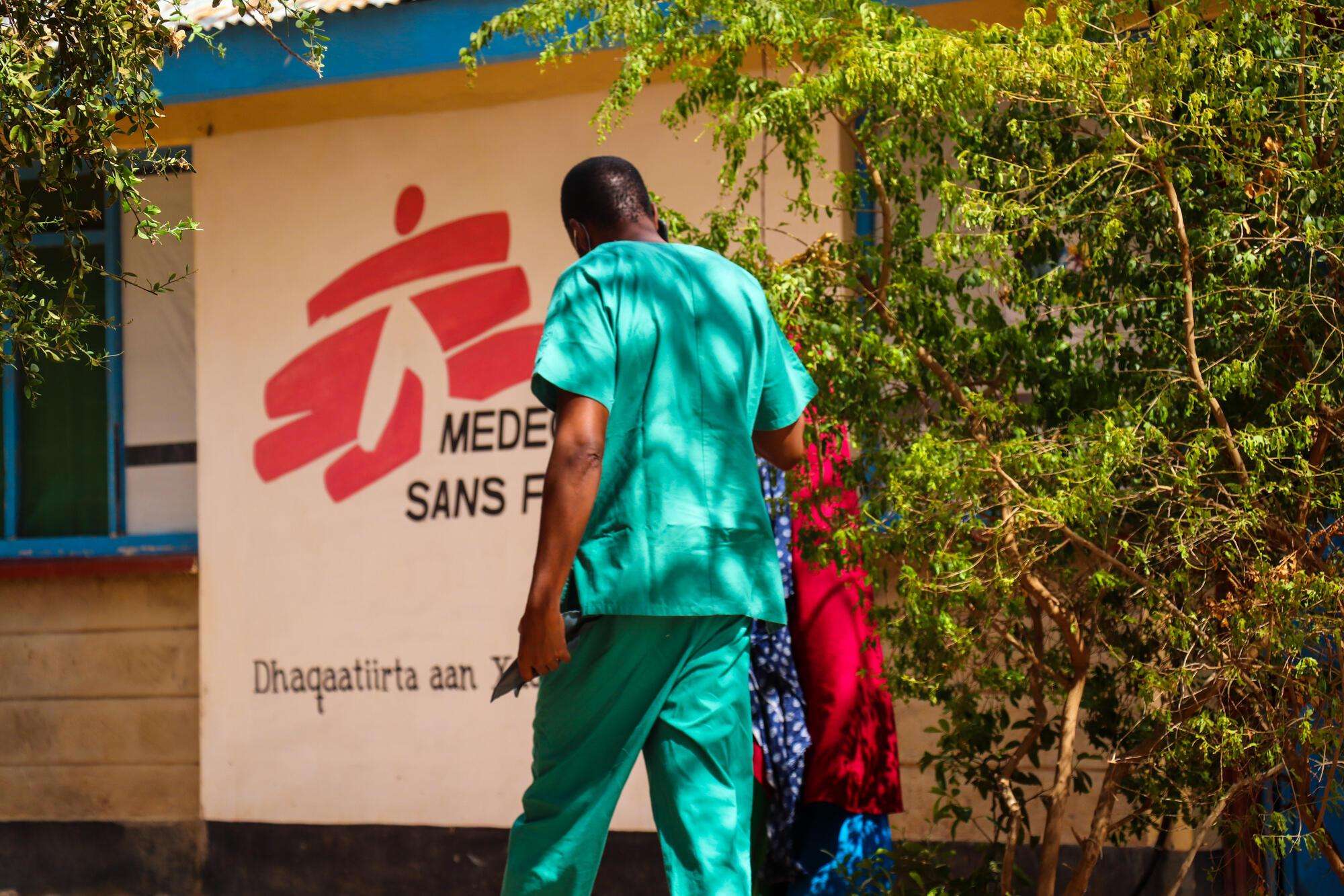 A nurse walks a patient into the consultation room in MSF's hospital in Dagahaley camp, Dadaab. 