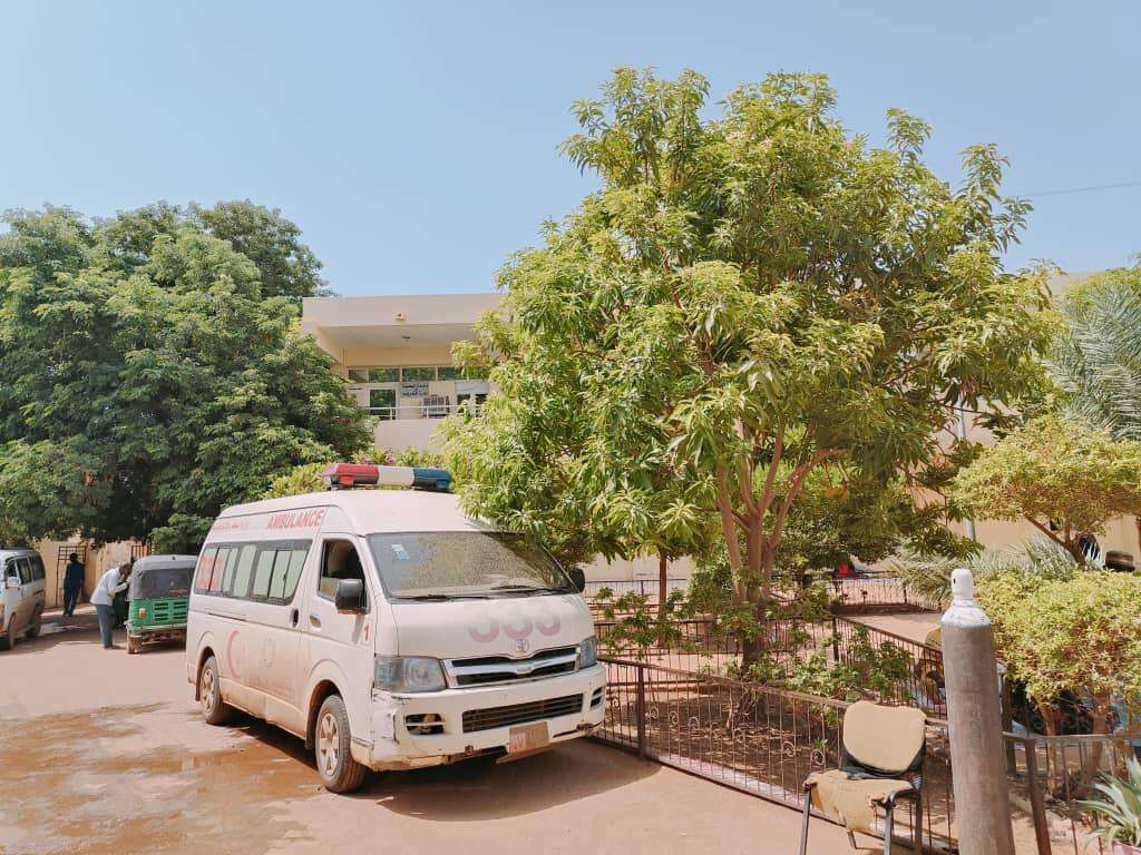 An ambulance parked by a tree outside MSF-supported Al Nao hospital in Omdurman, Sudan.