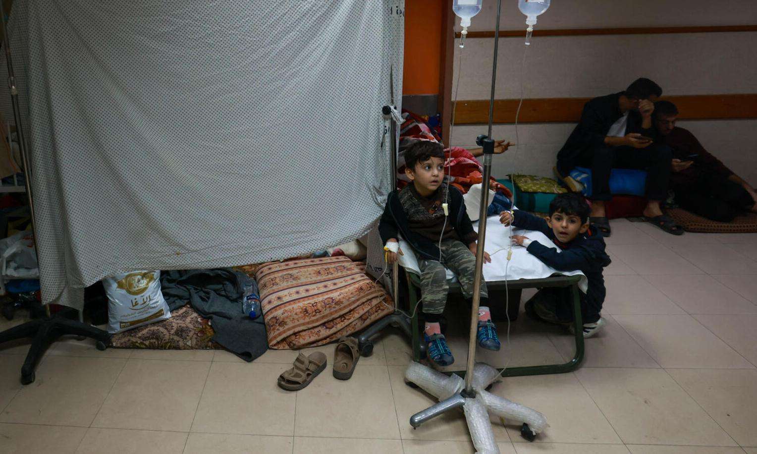 Patients on the floor at Al Aqsa hospital in Gaza with a sheet.