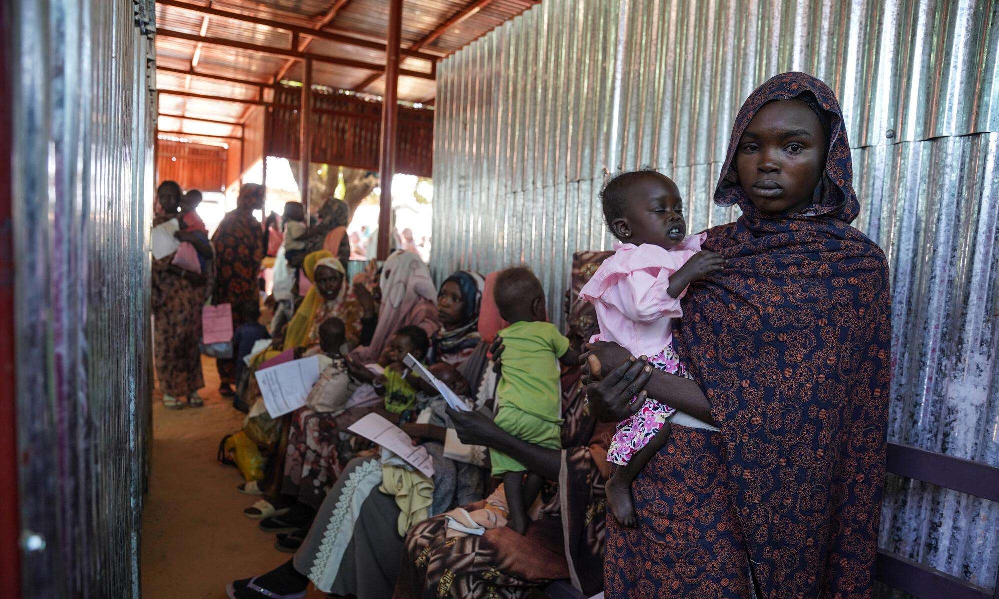A mother holds her child at MSF's clinic in Zamzam camp in Sudan.