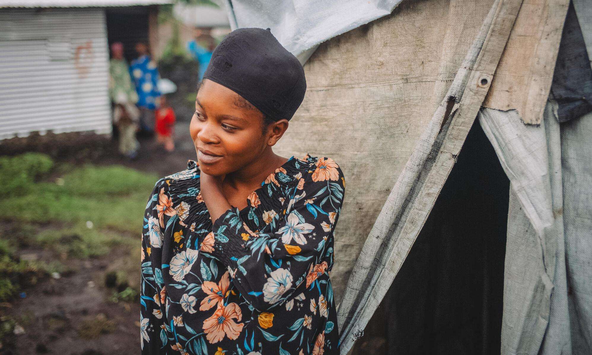 A young woman in front of her makeshift tent in Kanyaruchinya camp for displaced people in DR Congo.