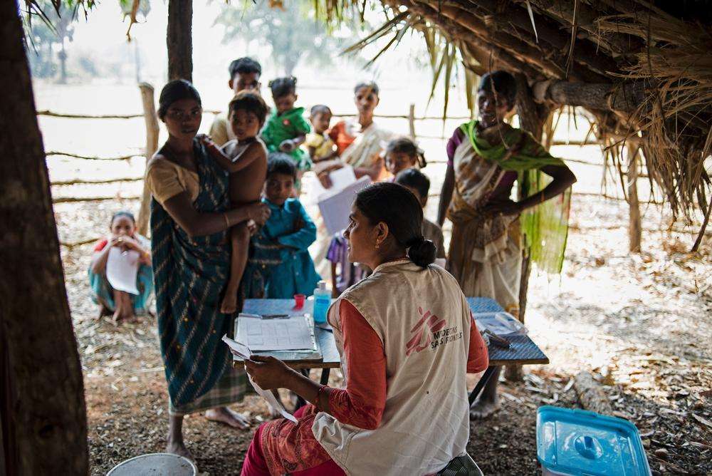An MSF staff member consulting with patients