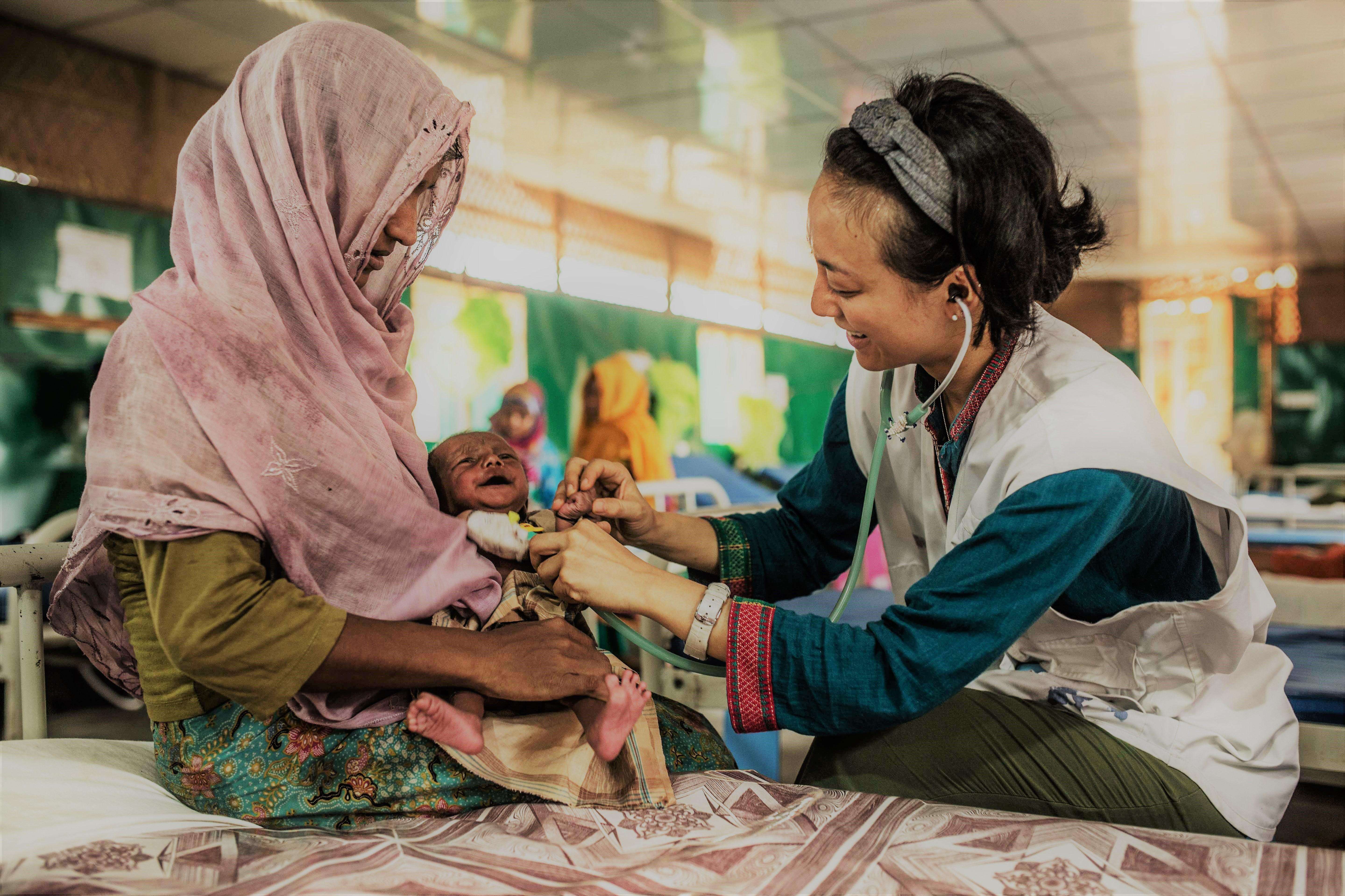 MSF fieldworker providing care to a child in the MSF hospital in Goyalmara.