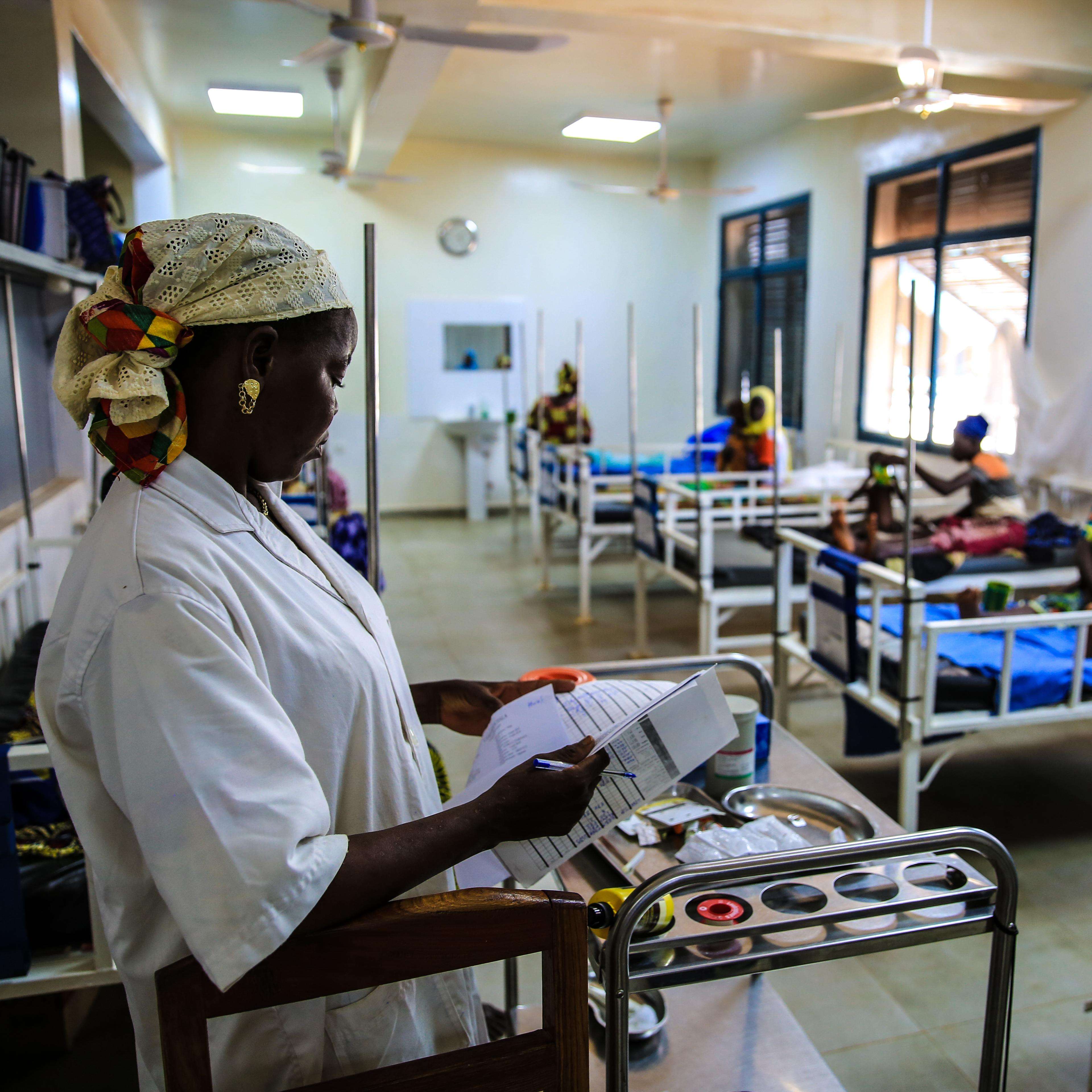  An MSF nurse checks the ﬁle of a child being treated for malnutrition