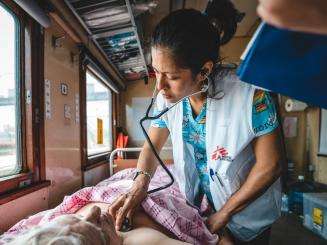 Dr. Guadalupe Garcia Noria monitors a patient inside the inpatient department of the MSF medical team during a journey from Pokrovsk, eastern Ukraine to Lviv, in western Ukraine.