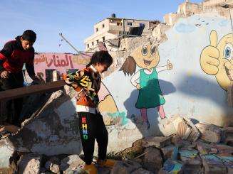 Palestinian children play in the rubble in Gaza.
