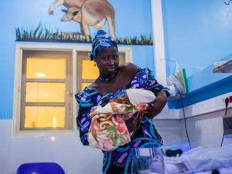 A Nigerian woman holds her newborn baby at Jahun Hospital.