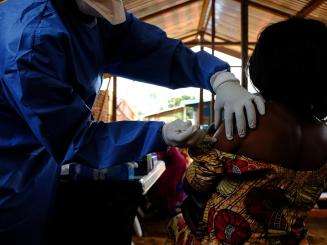 A health worker administers an Ebola vaccine at the MSF-supported health center of Kanzulinzuli, in Beni, DRC.