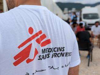 Person wearing a white T-shirt with Doctors Without Borders logo on the back