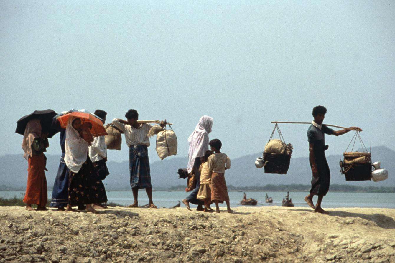 Rohingya refugees carry their belongings in Bangladesh.