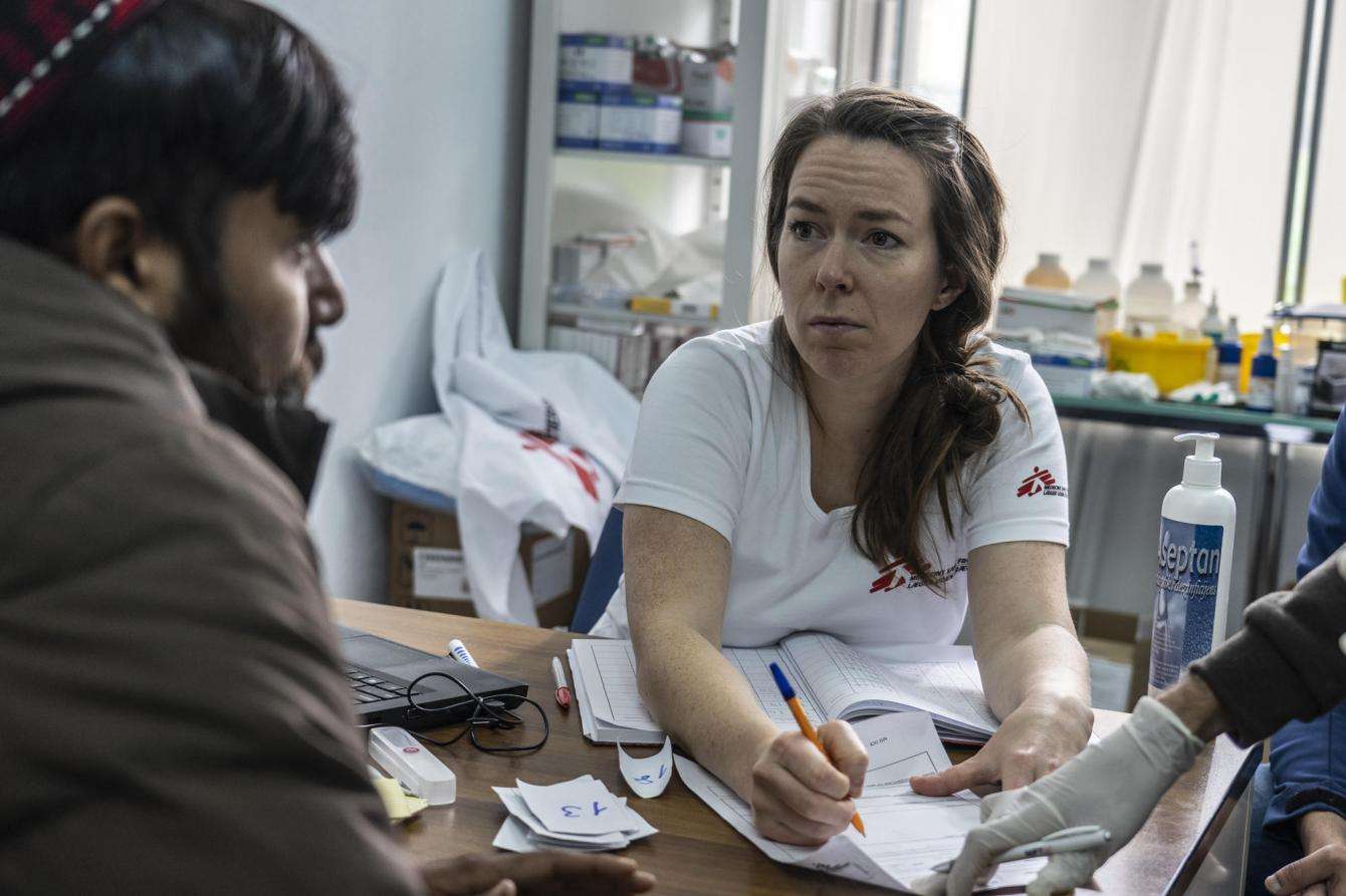 An MSF doctor exams a man from Afghanistan who is suffering from extensive skin infections in a local medical facility 2km away from Vucjak camp in Bosnia.
