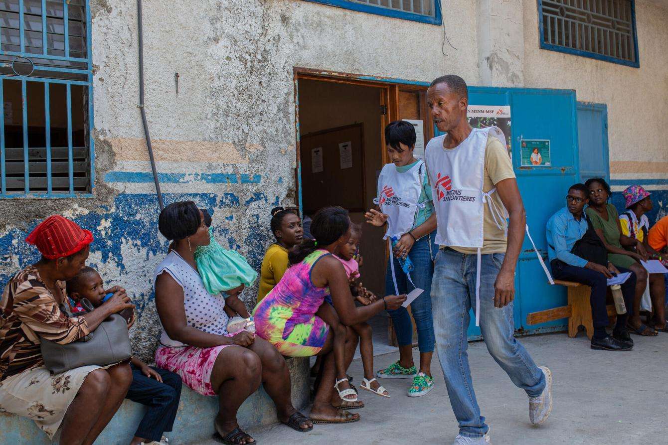 People wait outside an MSF mobile clinic in Haiti.