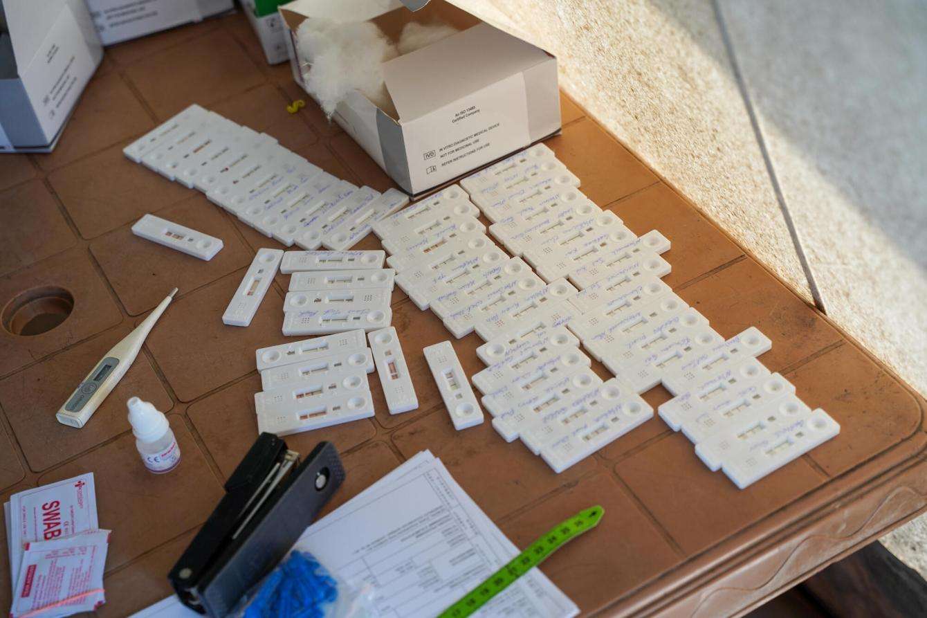 Malaria tests in the form of little plastic containers are spread out across a wooden table at the MSF clinic in Toch village, South Sudan.