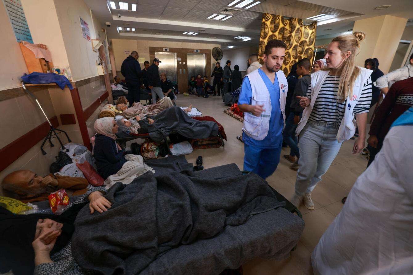 MSF staff walk through the halls of Al Aqsa hospital in Gaza.