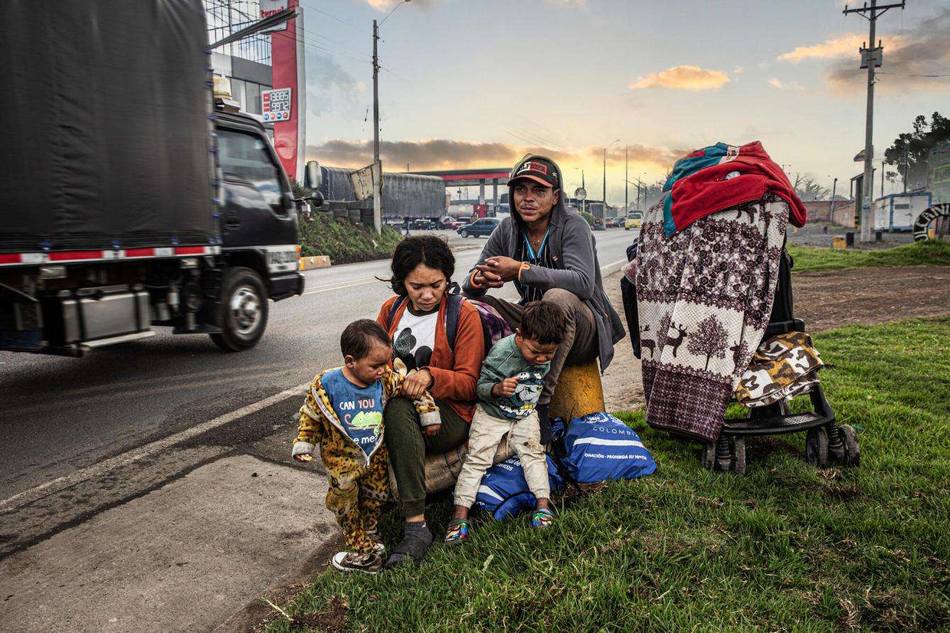 A migrant family by the side of the road as they cross through Ecuador, Colombia and Panama