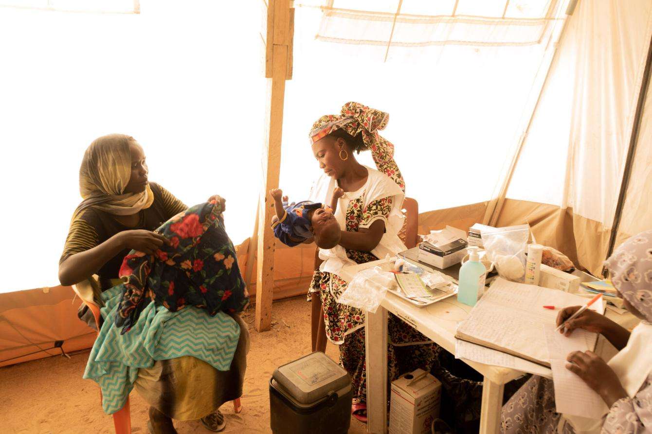 Children are examined, measured, and weighed inside the MSF clinic in Dogdore camp.