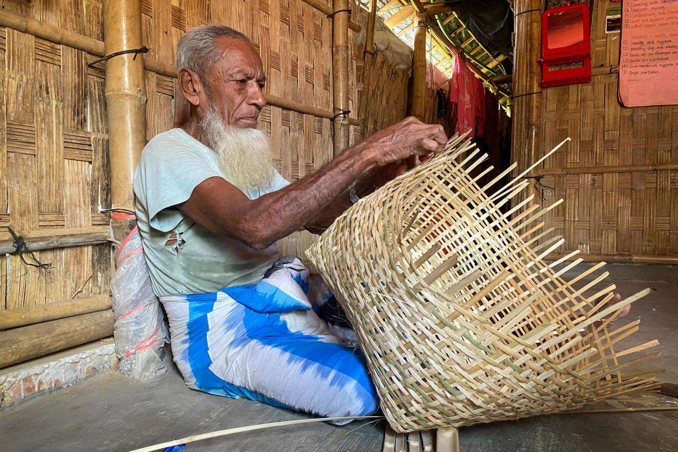 Nur Mohammad, 79, crafts chicken coops out of bamboo.