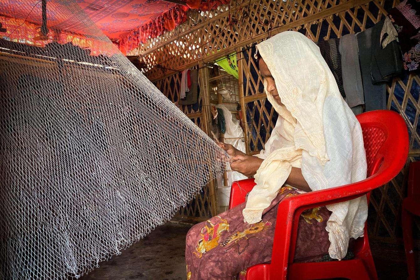 Zainura, 44, crafts fishing nets to earn money and provide food for her family.