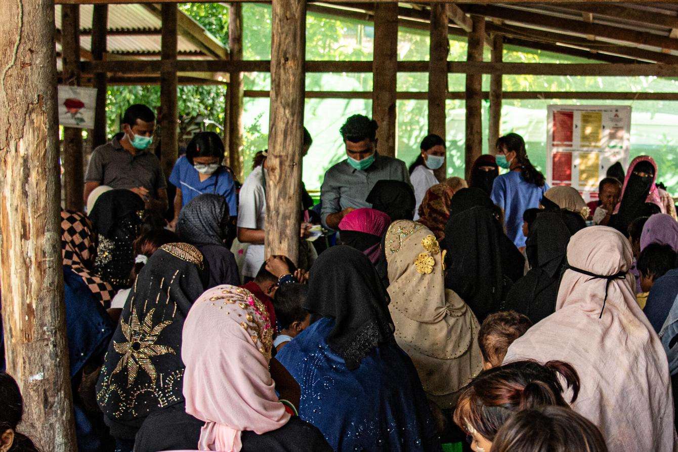 Women wait in line at a mobile clinic in Northern Rakhine state