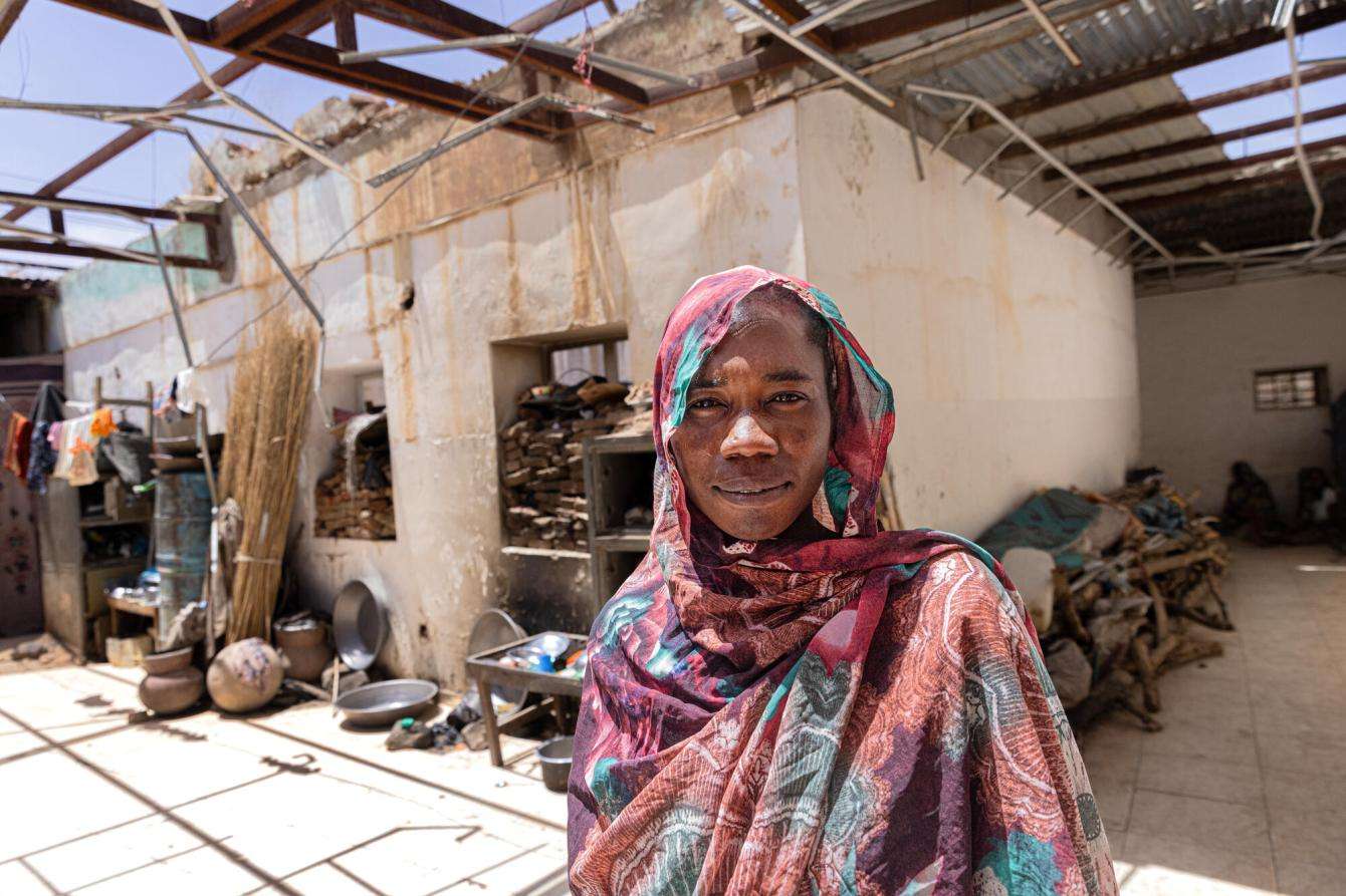 A displaced woman from Al-Hasahisa camp, Zalingei, Sudan sheltering in an abandoned and looted bank.