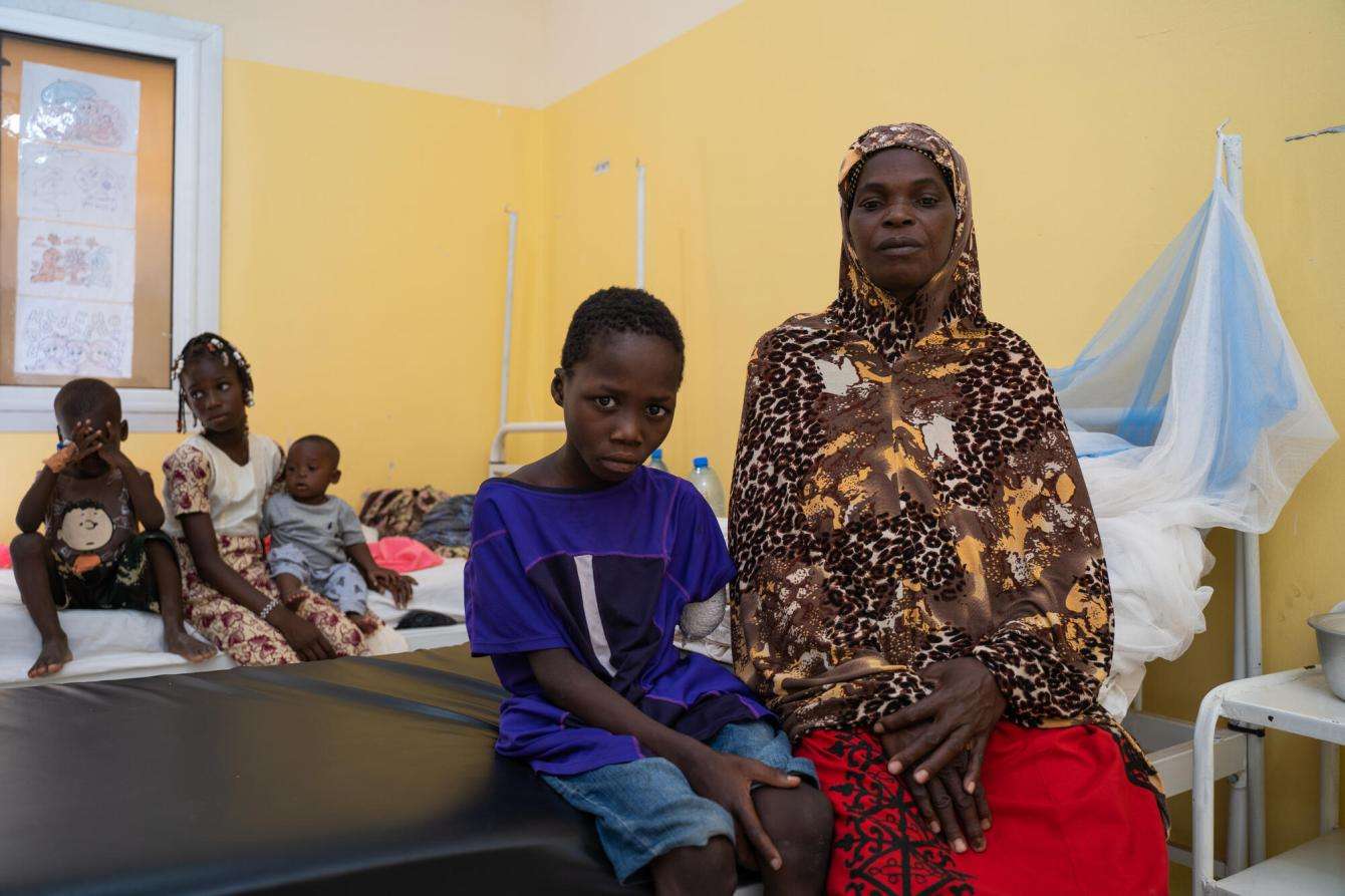 A mother and boyo sitting on a hospital bed in Niono, Mali. 