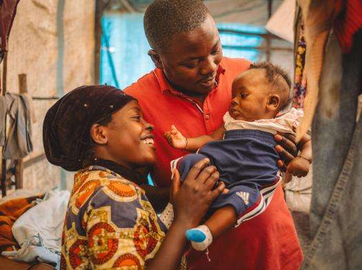 Francine and Jean-de-Dieu, both from Kiwanja in Rutshuru territory, look after their 3-month-old son Amini Naël inside their tent in the Kanyaruchinya IDP site north of Goma, DR Congo.
